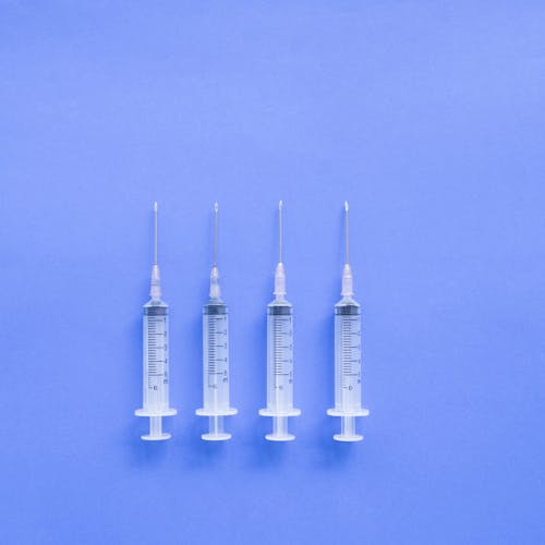 Medical syringes placed on blue surface
