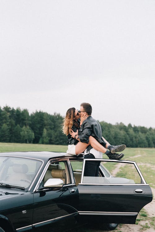 Man and Woman Kissing on the Car
