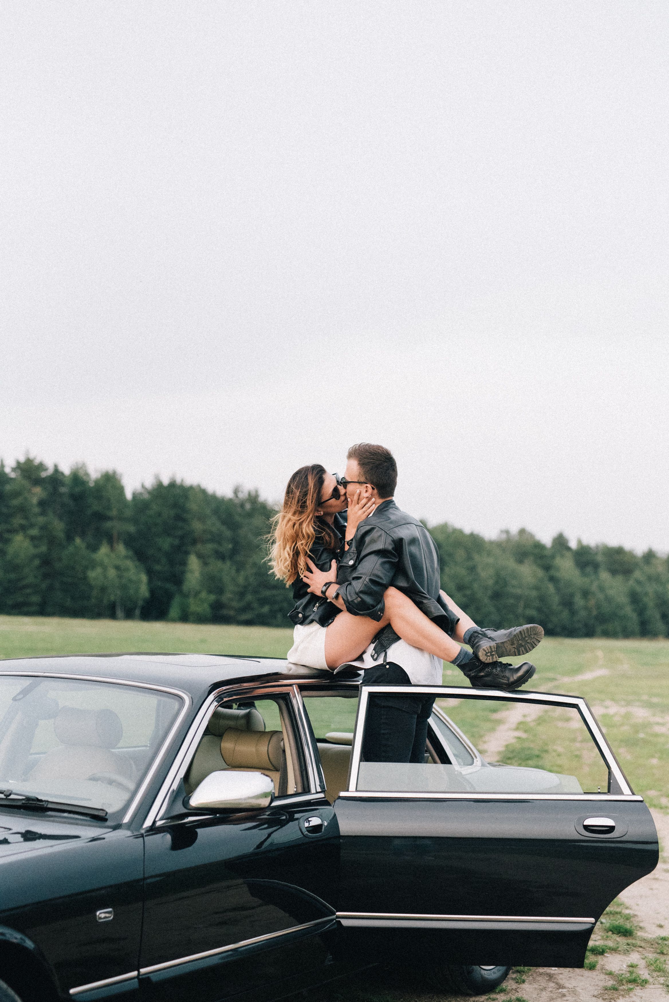 Woman in Leather Jacket and Man in Brown Jacket Kissing · Free Stock Photo