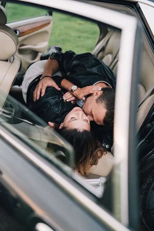 Man and Woman Kissing Inside the Car