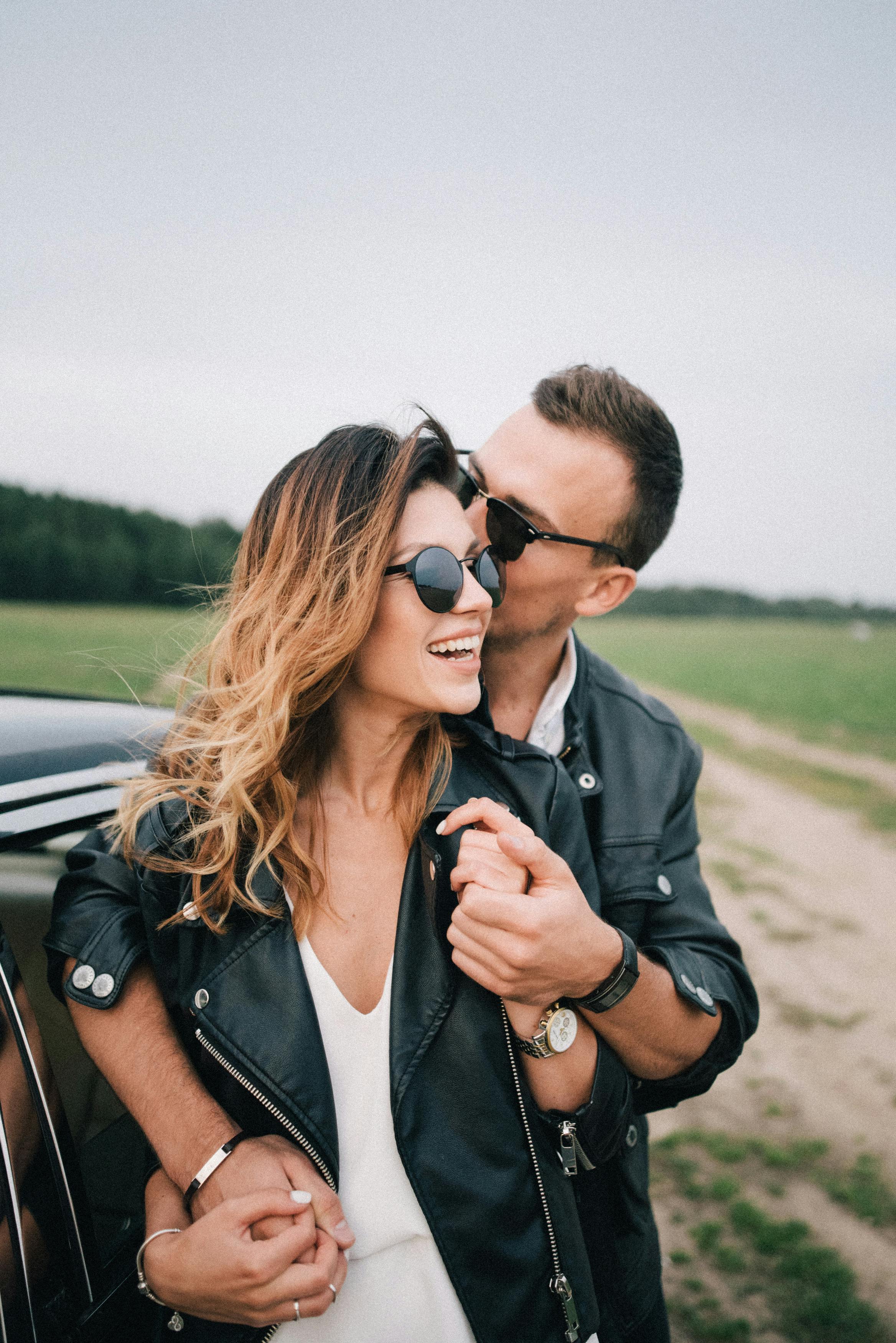 Woman in Leather Jacket and Man in Brown Jacket Kissing · Free Stock Photo