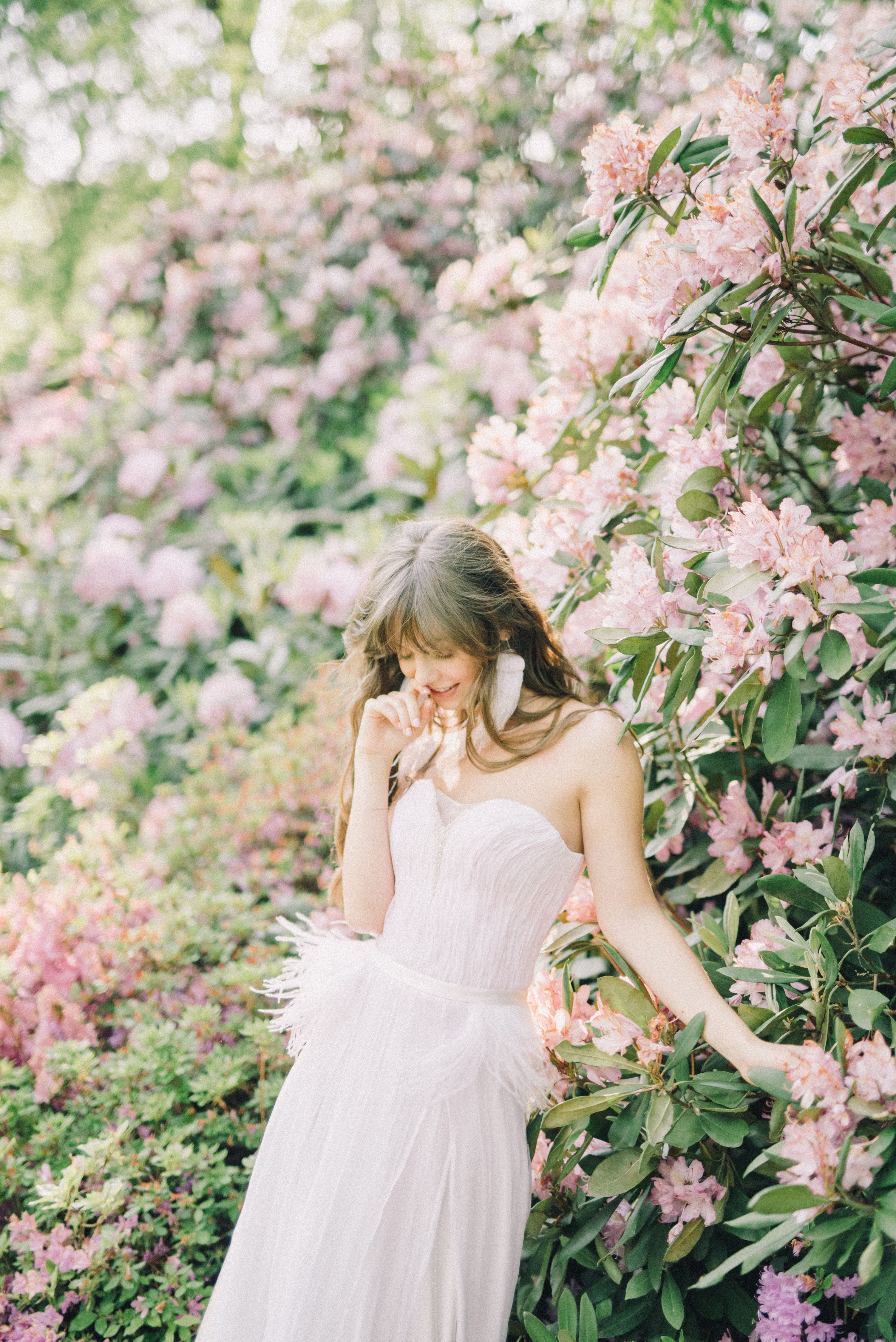 A Woman in White Dress Standing Near Pink Flowers · Free Stock Photo