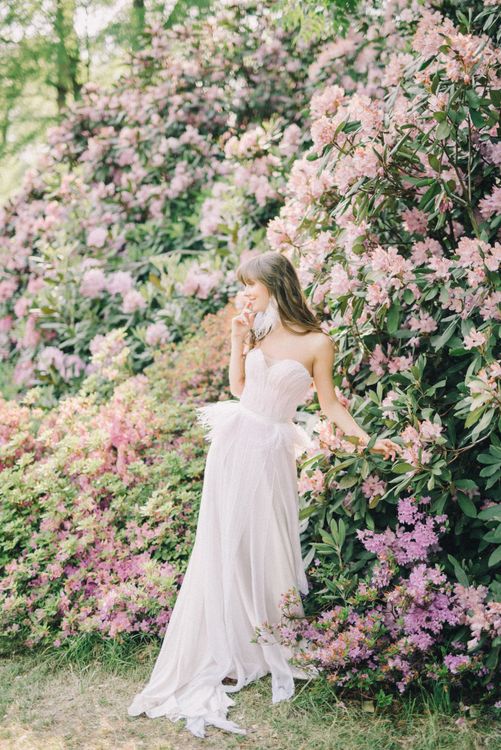 A Woman in White Dress Standing in Front of Pink Flowers · Free Stock Photo