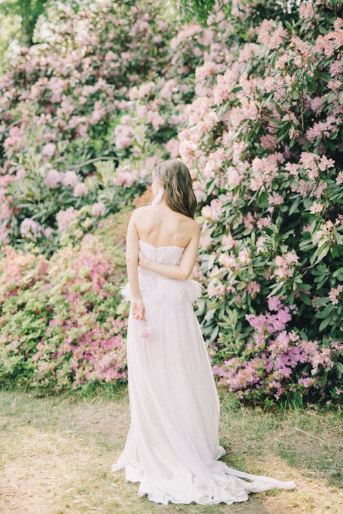 Woman Wearing a Dress Walking on a Botanical Garden