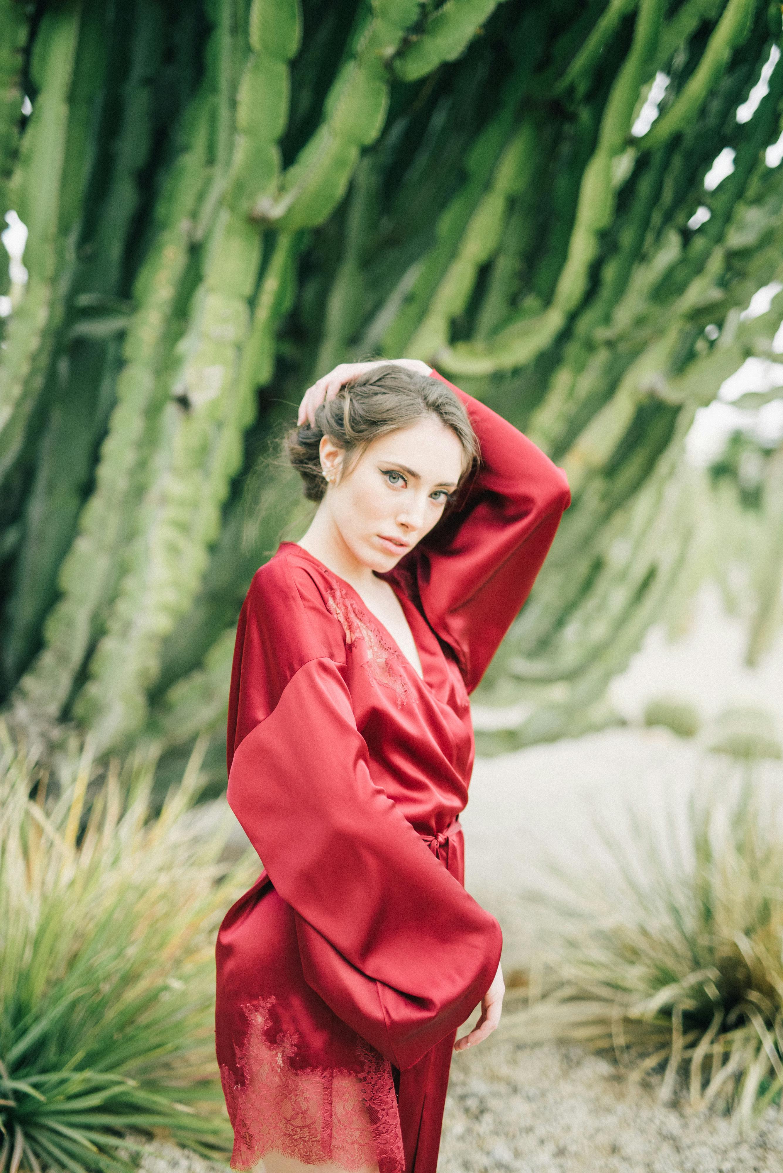 a woman in red robe posing at the camera