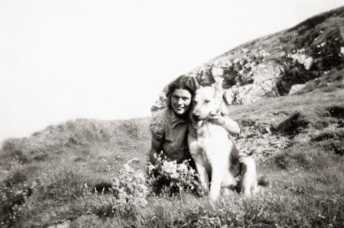 Old Photo Of Woman With A German Sheperd on Grass Field