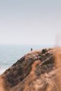 Person Standing on Brown Grass Mountain