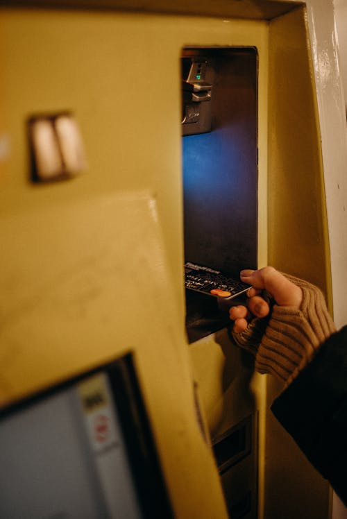 Person Holding Black Smartphone Near White Wall