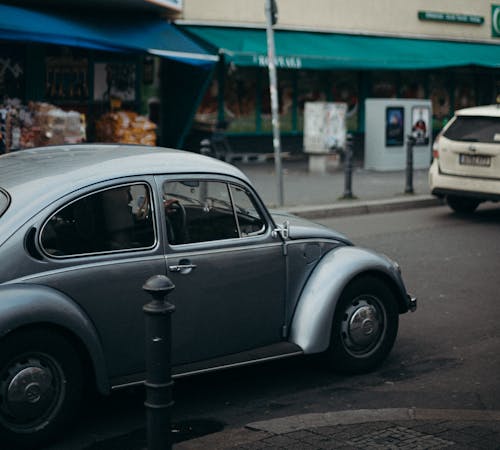 Silver Volkswagen Beetle Parked on Sidewalk