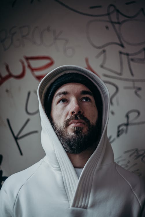 Man in White Hoodie Wearing Black and White Knit Cap