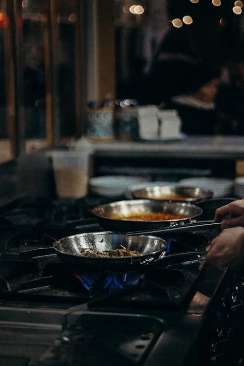 Person Cooking on Stainless Steel Bowl