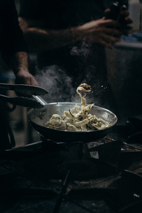 Person Cooking on Black Pan