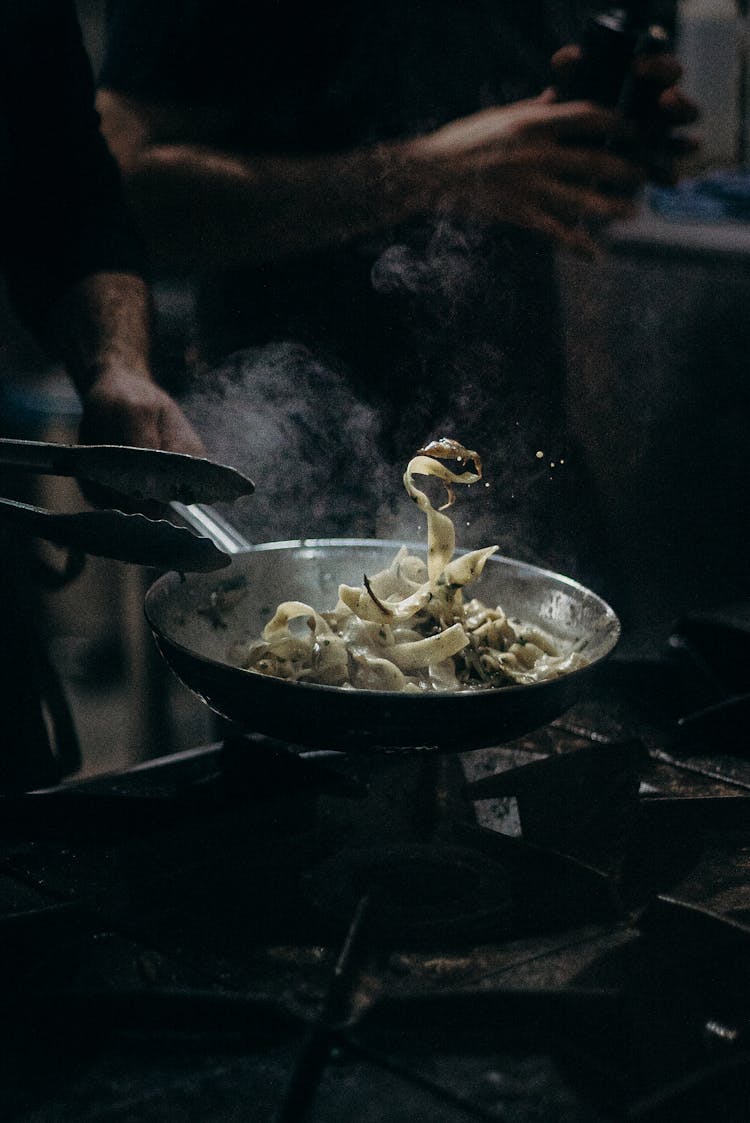 Person Cooking On Black Pan
