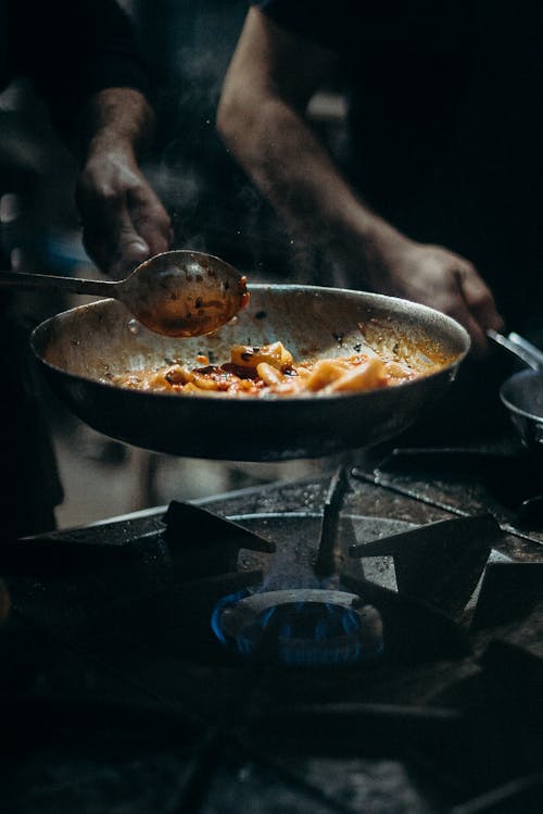 Person Cooking on Black Pan