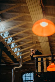 A warm industrial loft with wooden beams and cozy lighting, capturing a moment.