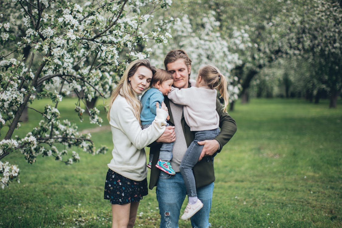 Free Happy Family Hugging Outdoors Stock Photo