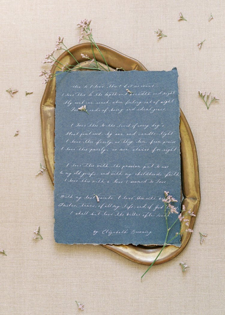 Blue Sheet Of Paper With Handwriting On Brown Oval Tray