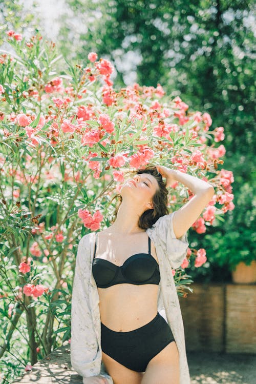 Free Photo of Woman Under a Flowering Plant Stock Photo