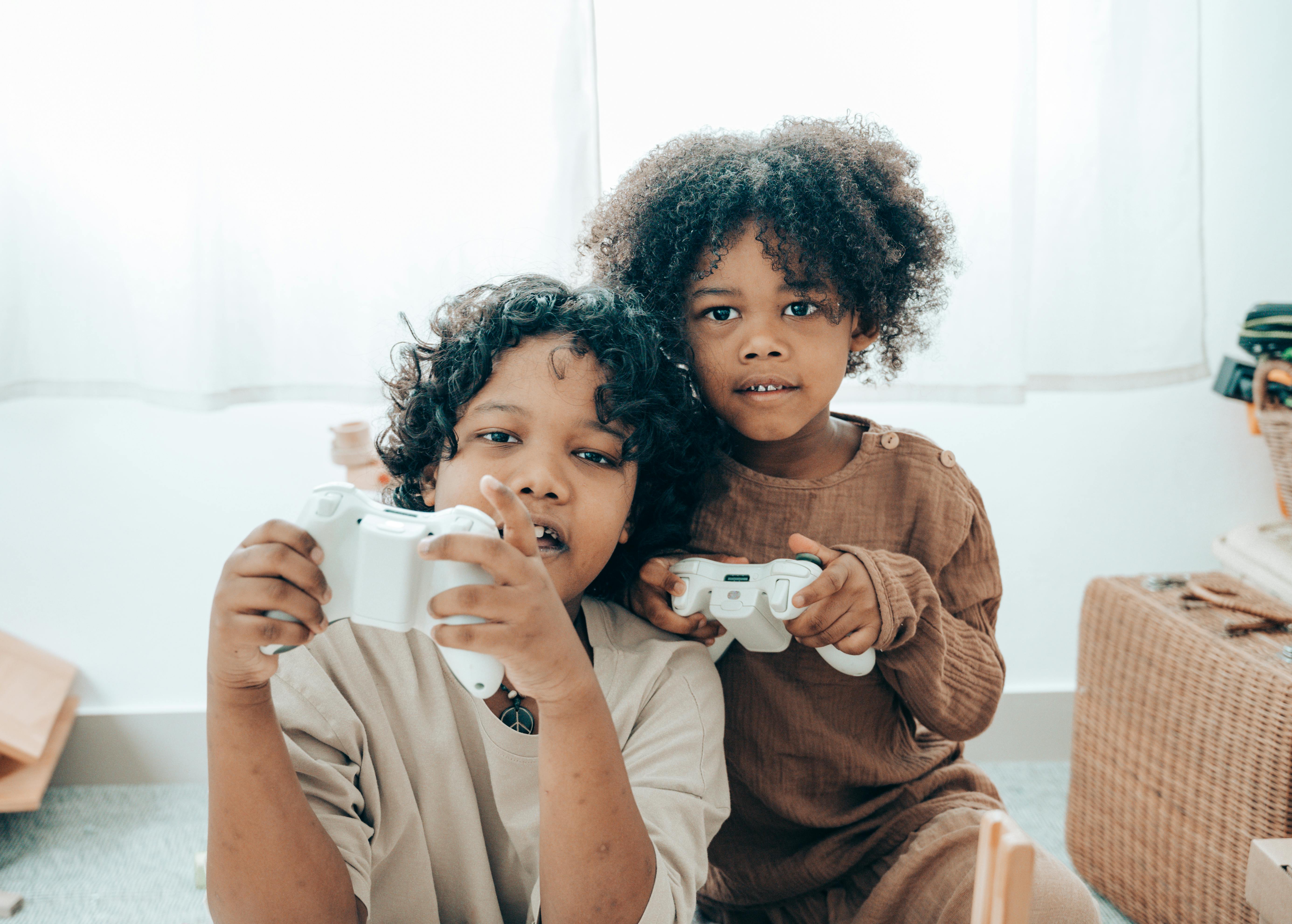 positive black children using joystick during free time