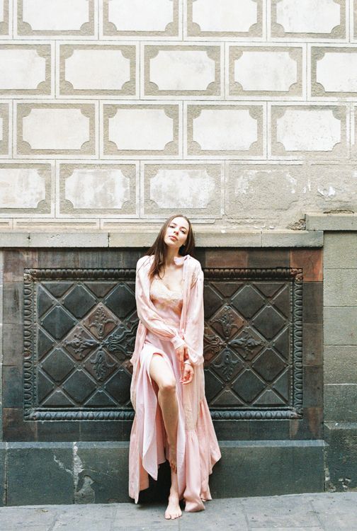 Woman in Pink Dress Standing Leaning on a Wall · Free Stock Photo
