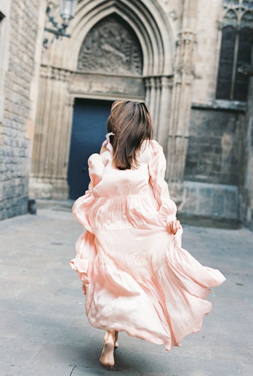 Woman in Pink Long Sleeve Dress Running