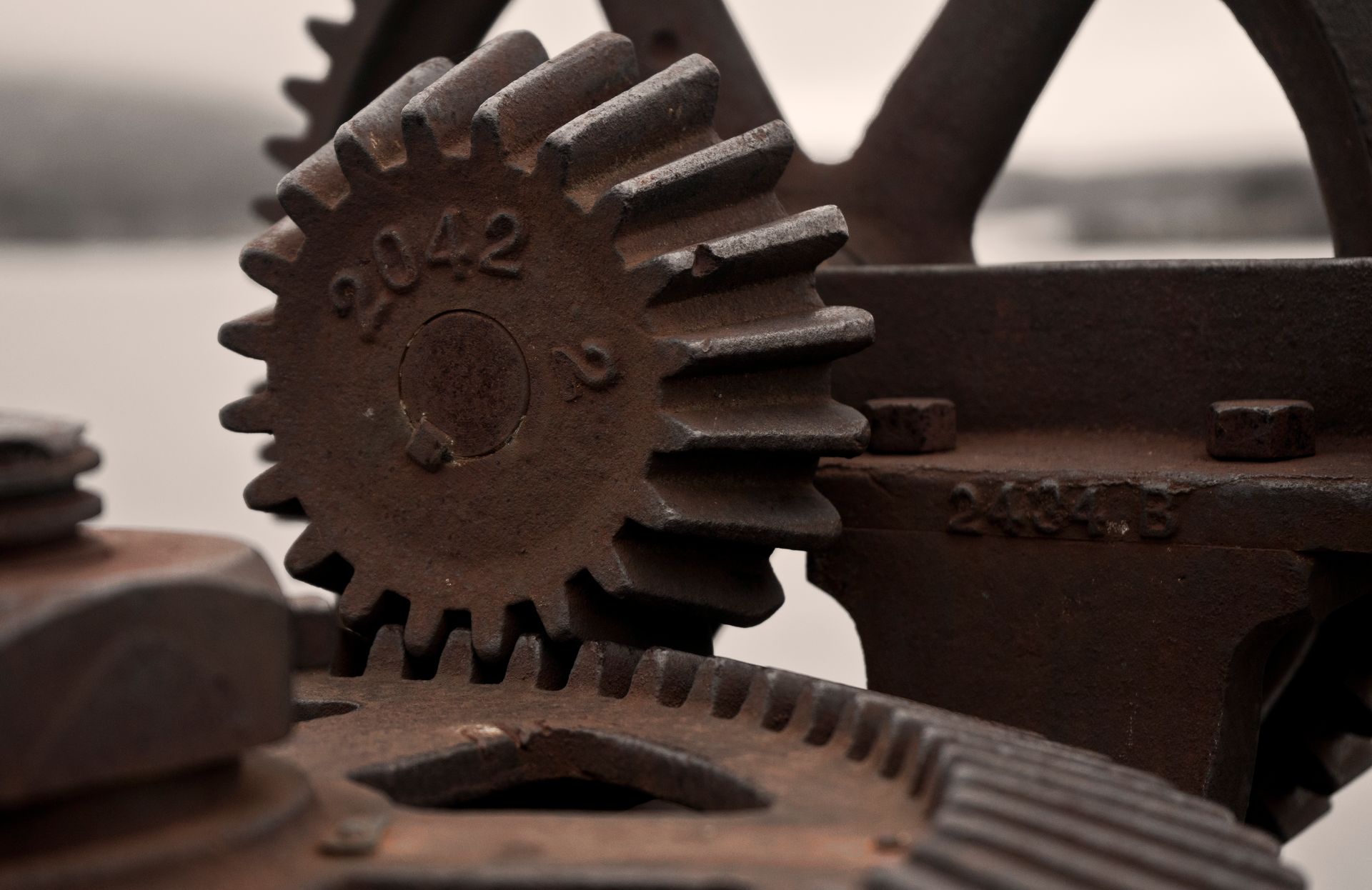 Close-up view of rusty gears, showcasing industrial machinery details and textures.