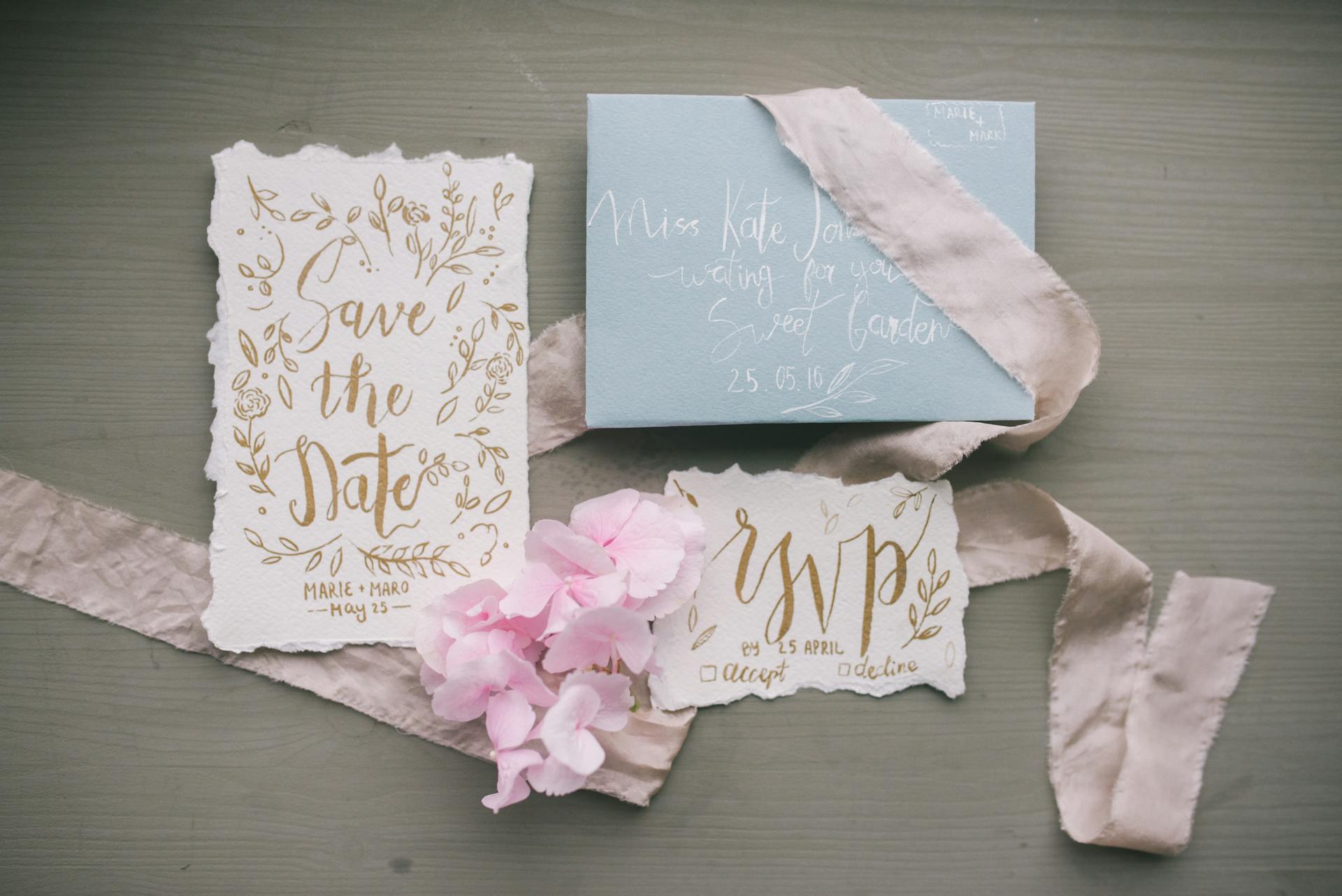 Stylish wedding invitation set with calligraphy, featuring RSVP and floral elements.