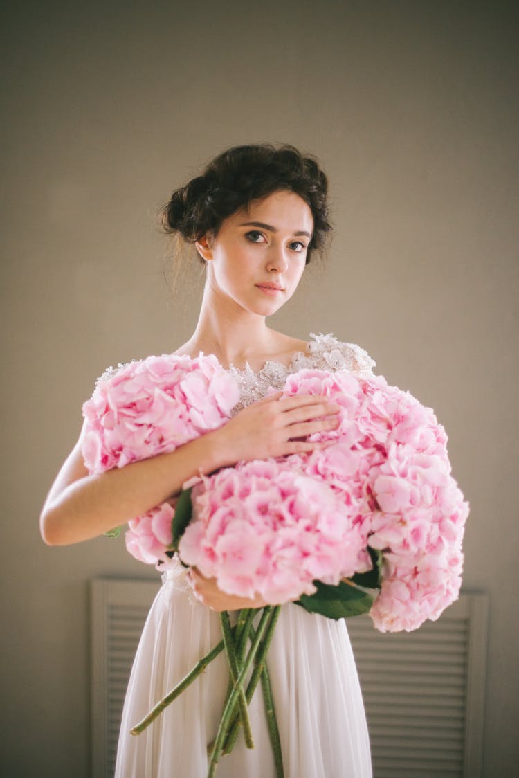 A Woman Holding Pink Large Flowers