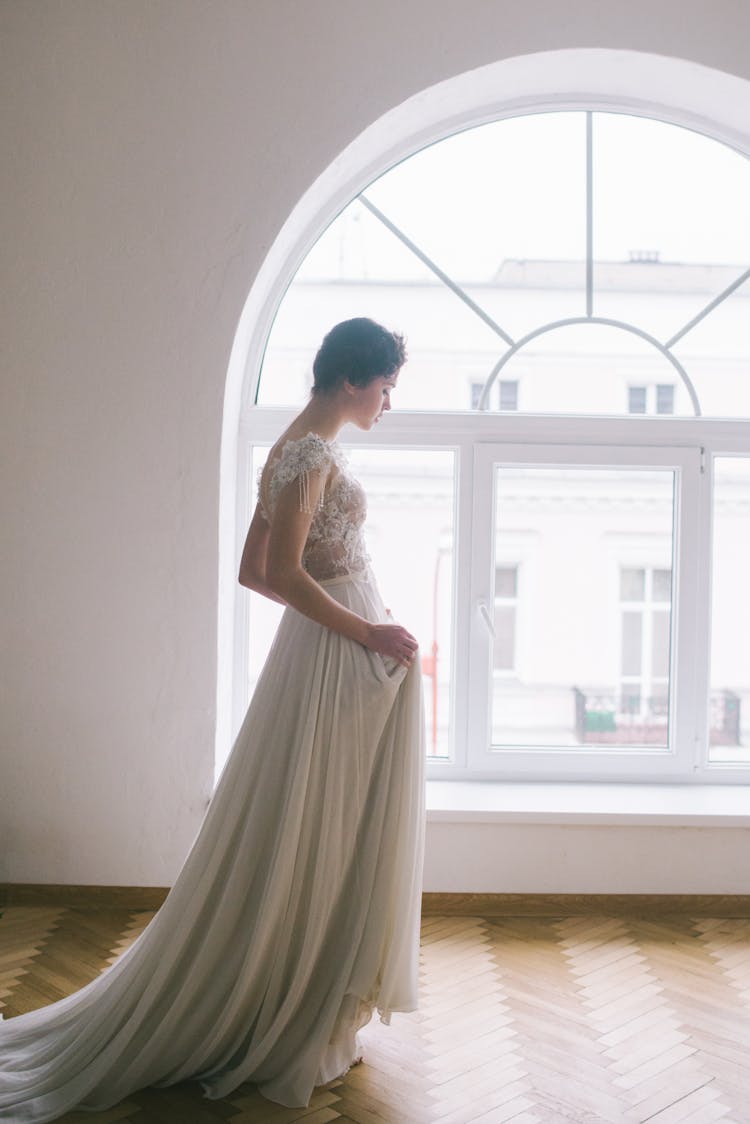 Young Woman Near Window In Living Hall