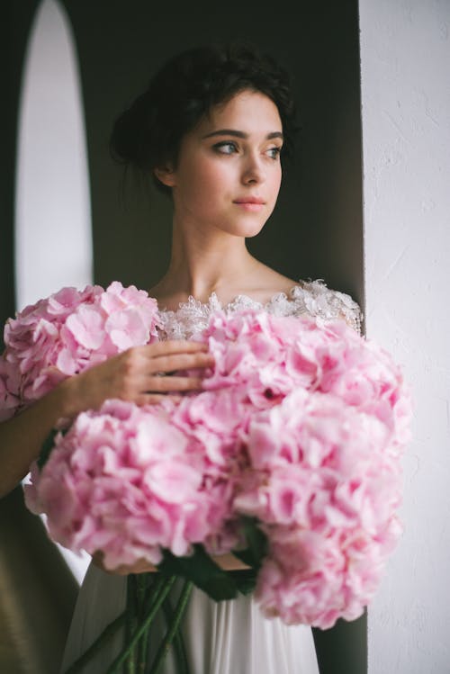 Beautiful Woman with Bouquets of Pink Flowers