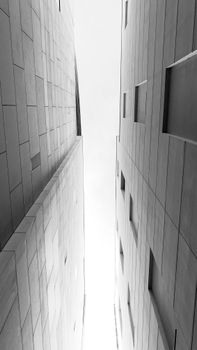 From below black and white of high contemporary style house walls with uneven surface in town