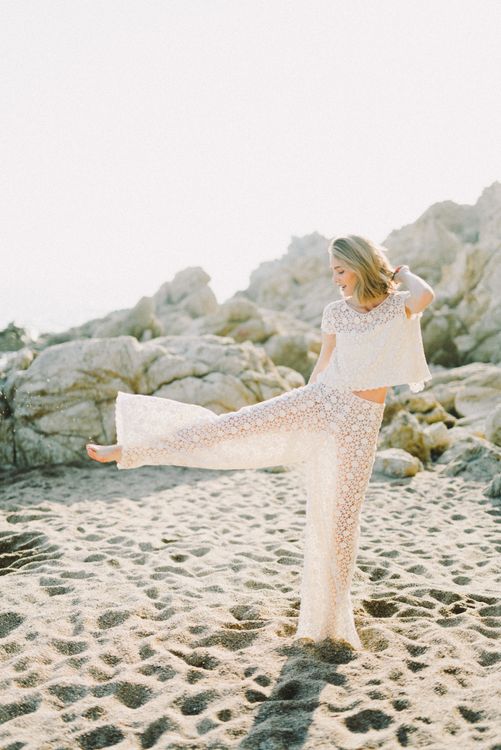 Woman in White Lace Dress Sitting on White Sand · Free Stock Photo