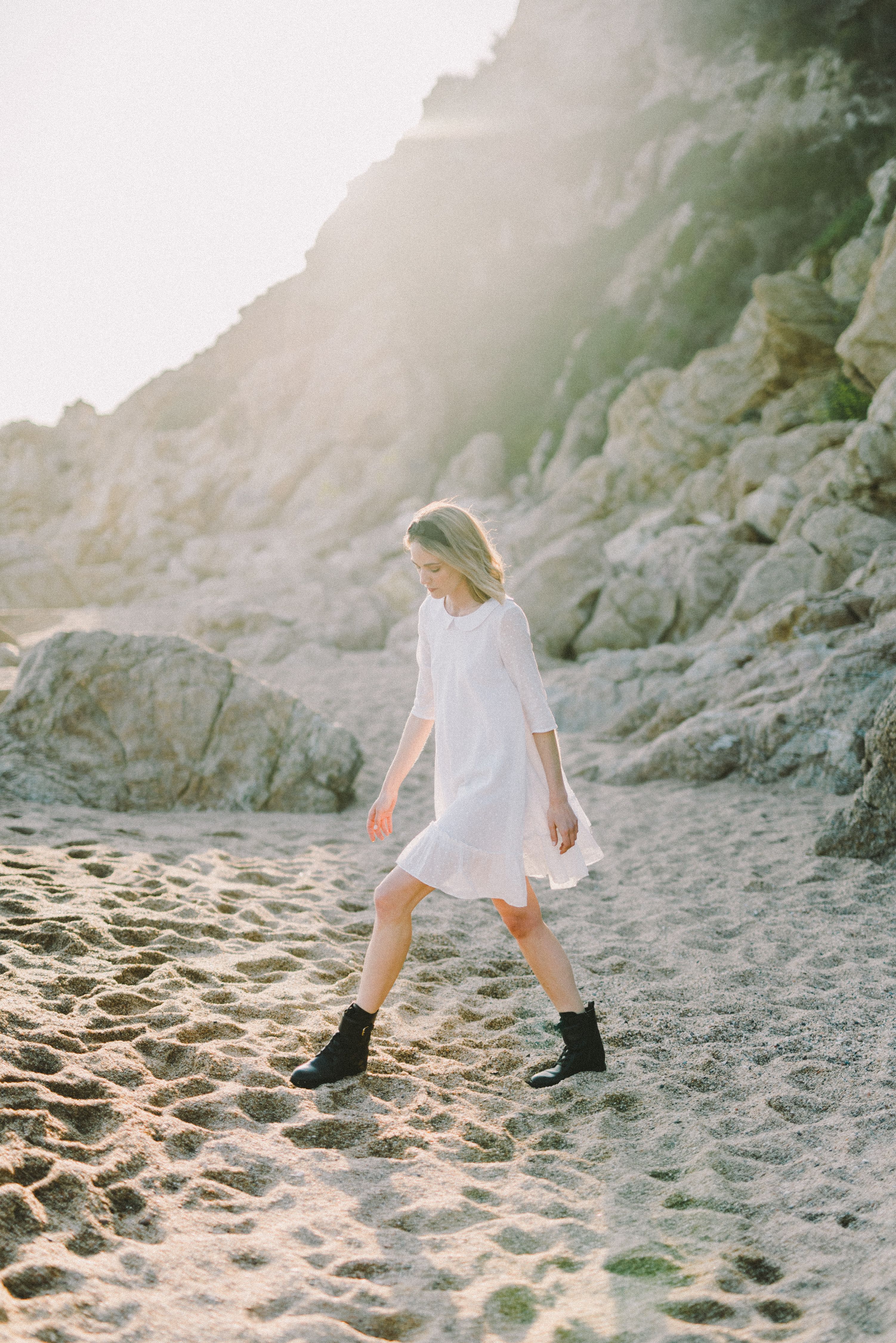 Woman in White Dress Walking on Sand · Free Stock Photo