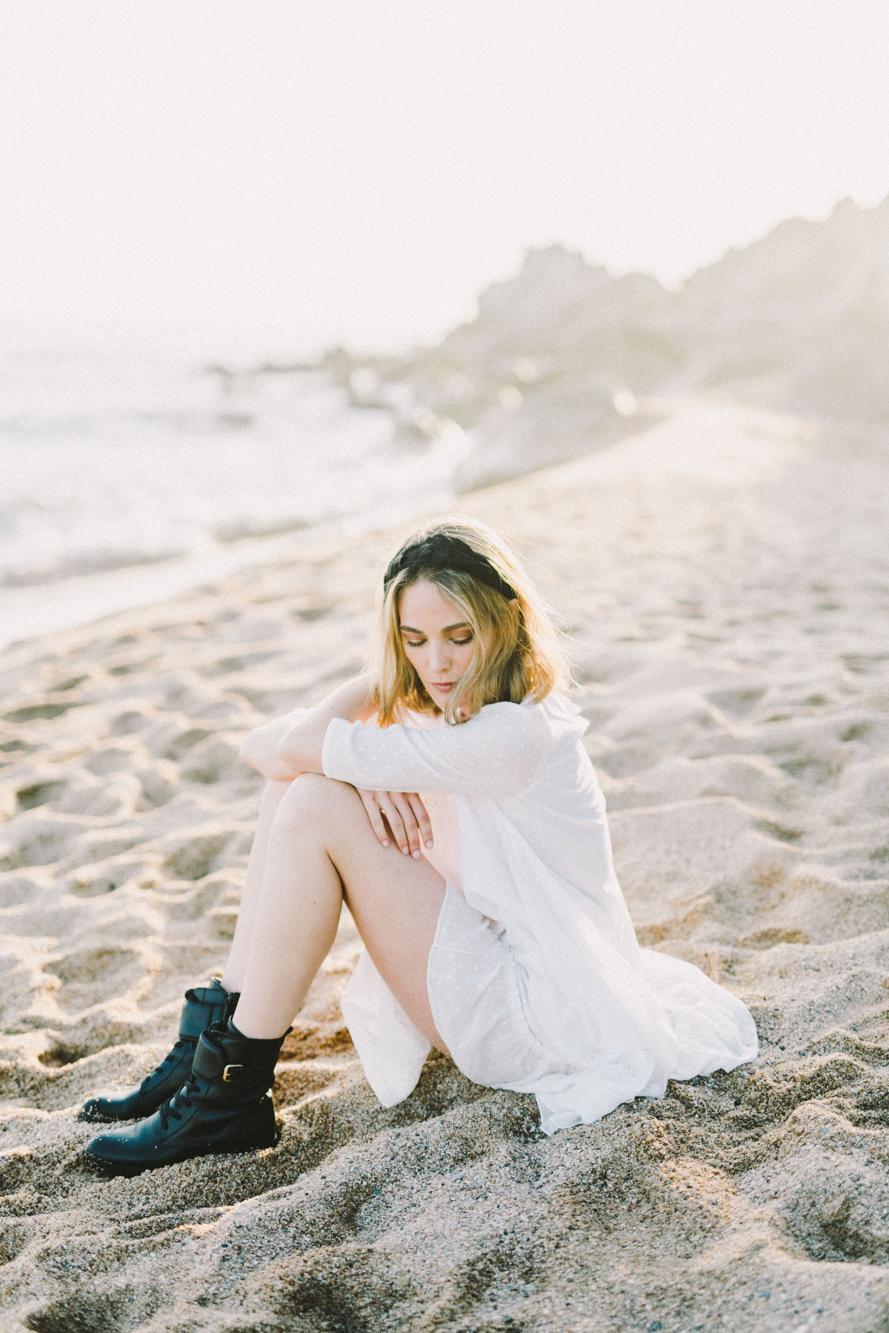 Woman in White Dress Sitting on Sand · Free Stock Photo