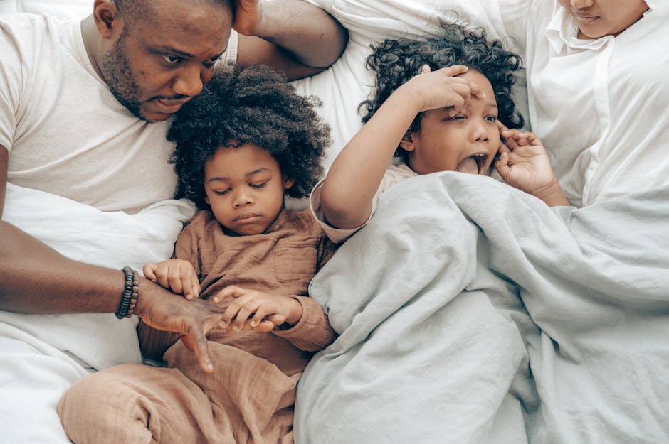 Photo by Ketut Subiyanto on Pexels From above of happy little ethnic girls cuddling crop parents while lying together in bed in morning - Photo by Ketut Subiyanto on Pexels