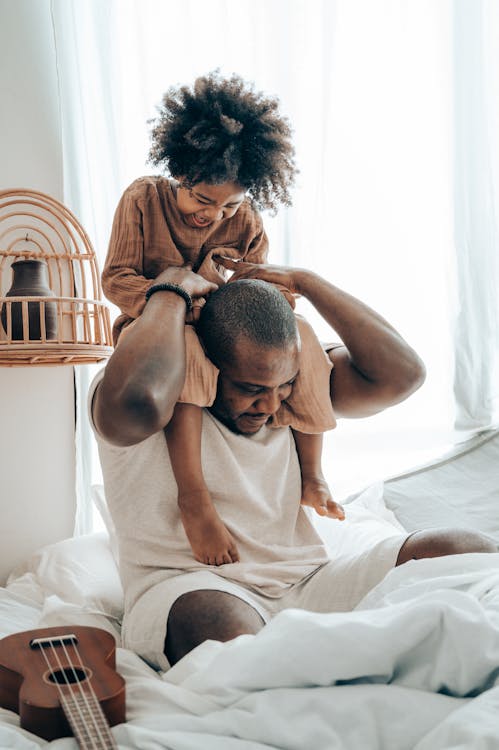 Free Father Playing With His Child in Bed Stock Photo