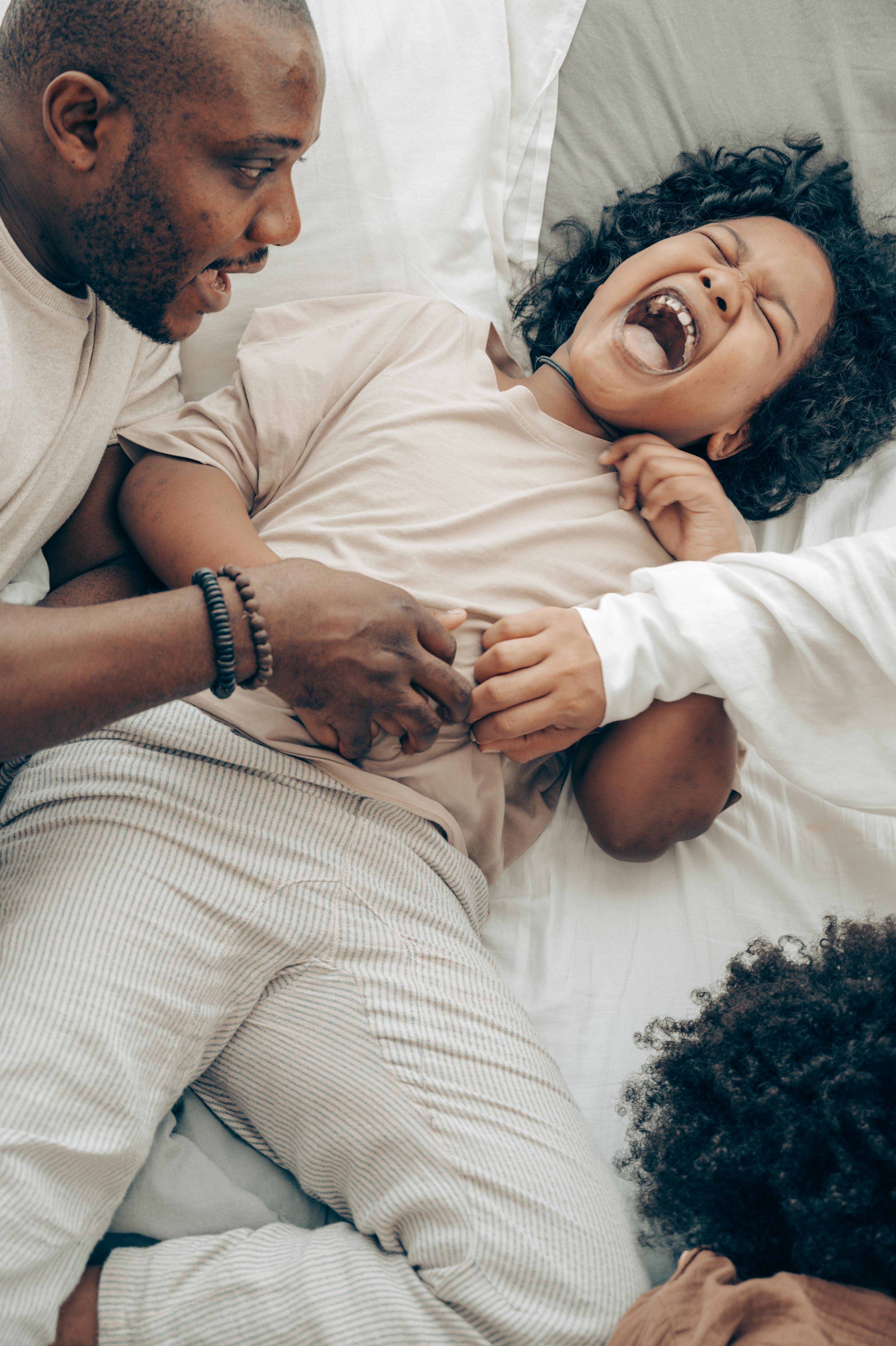 ethnic parent and child having fun at home