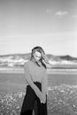 Woman in Gray Long Sleeve Shirt Standing on Field in Grayscale