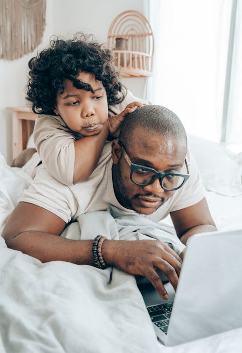 African American father with child using laptop