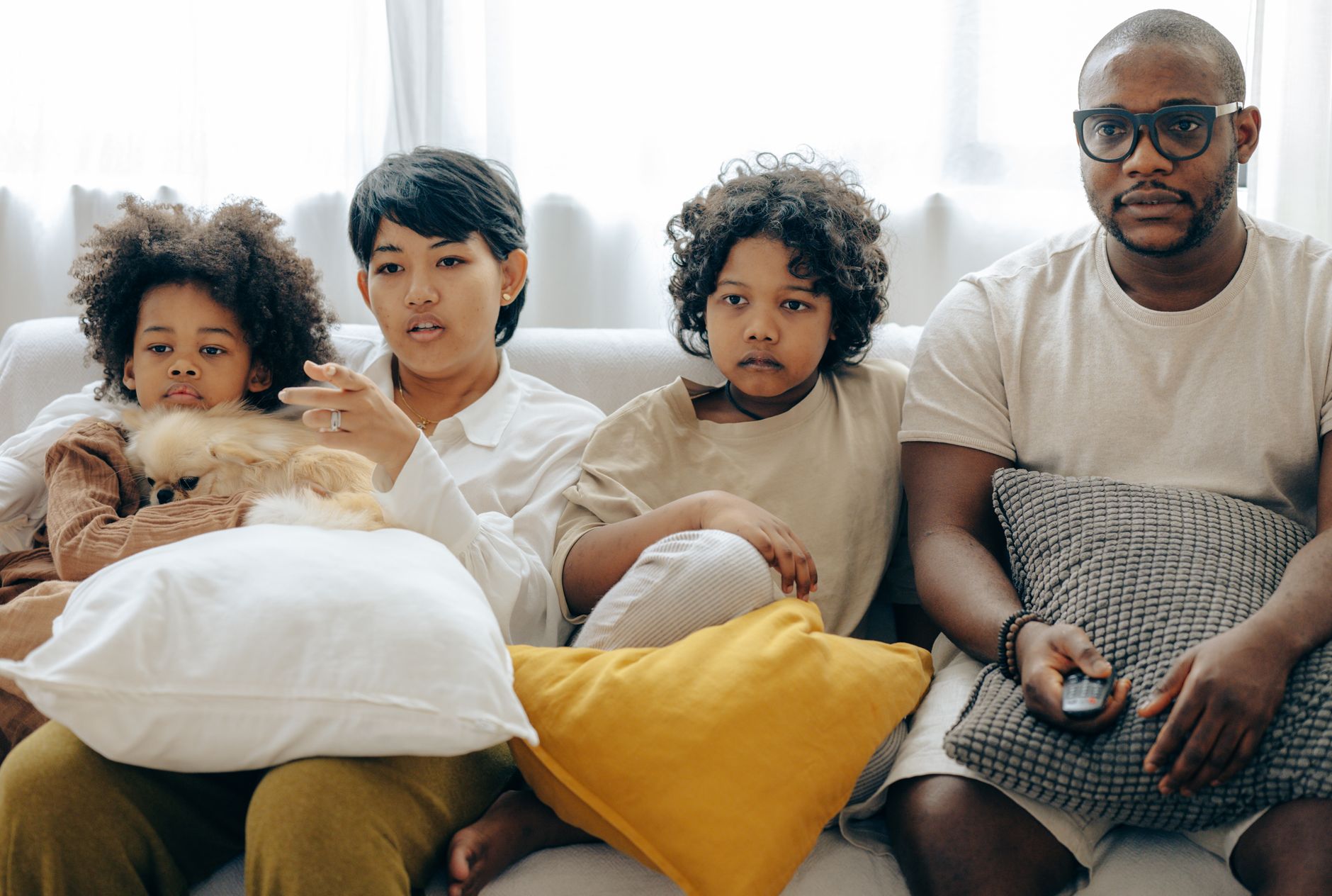 A family watching JioHotstar television shows and movies together in a warmly lit living room