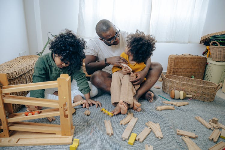 African American Man Playing With Kids At Home