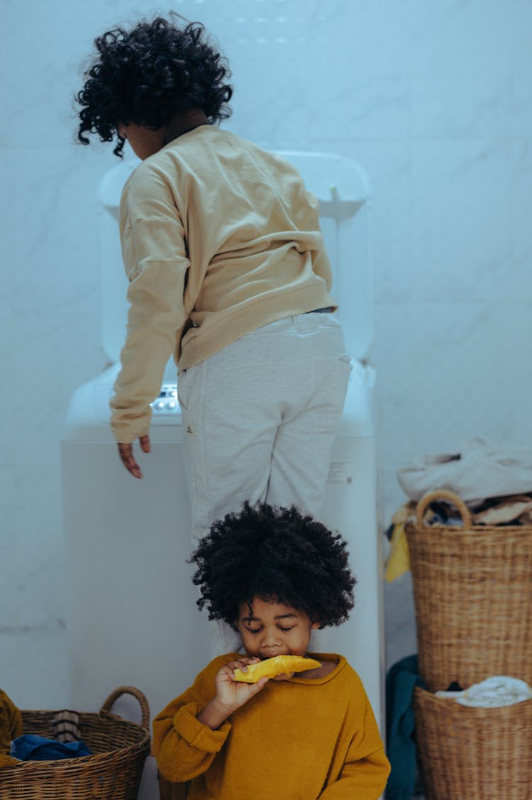 Content Black Siblings In Laundry Room