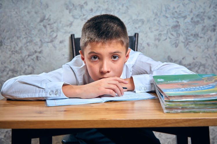 
A Boy Leaning On The Table