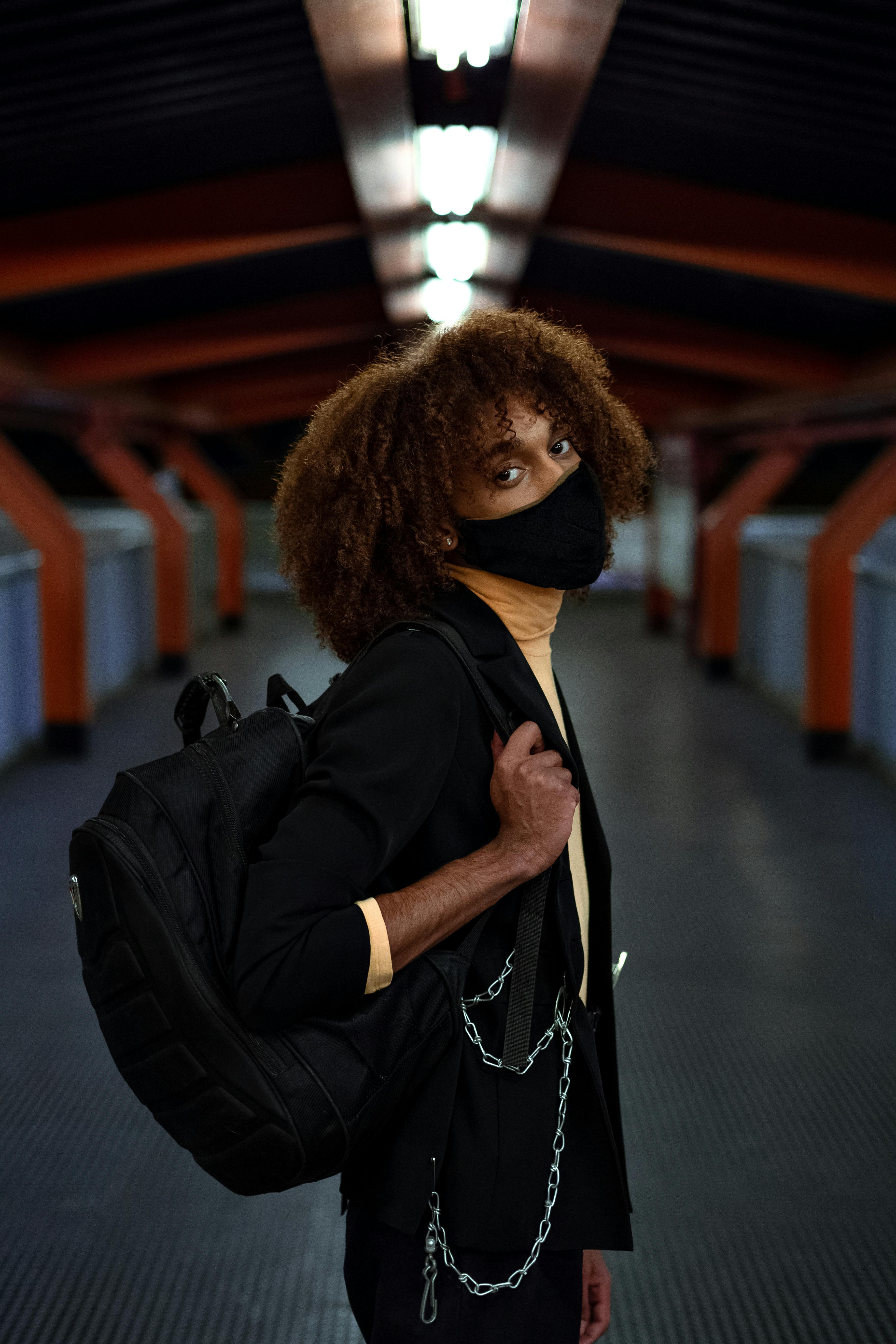young black man in protective mask in subway