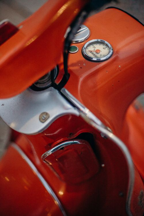 Free Detailed view of a classic red scooter dashboard with visible gauges. Stock Photo