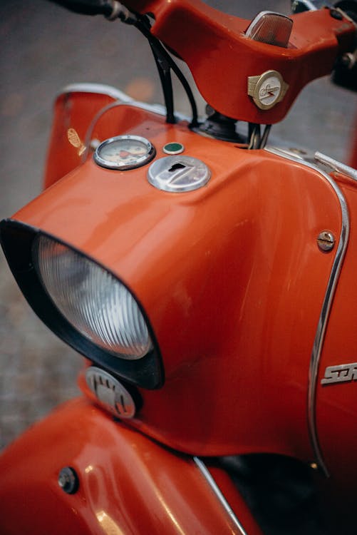 Red and Black Motorcycle With Black and Silver Motorcycle Headlight