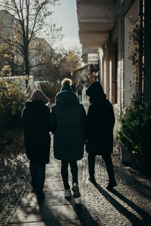 Man and Woman Walking on Sidewalk