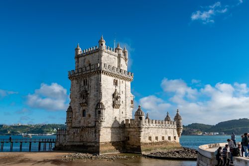 Free Scenic view of Belem Tower against a blue sky, Lisbon's iconic landmark. Stock Photo