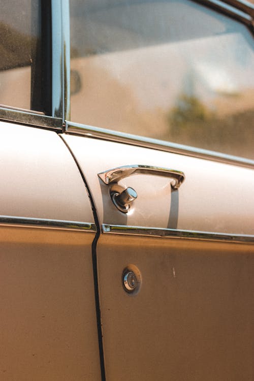 Door of vintage car parked in sunny day