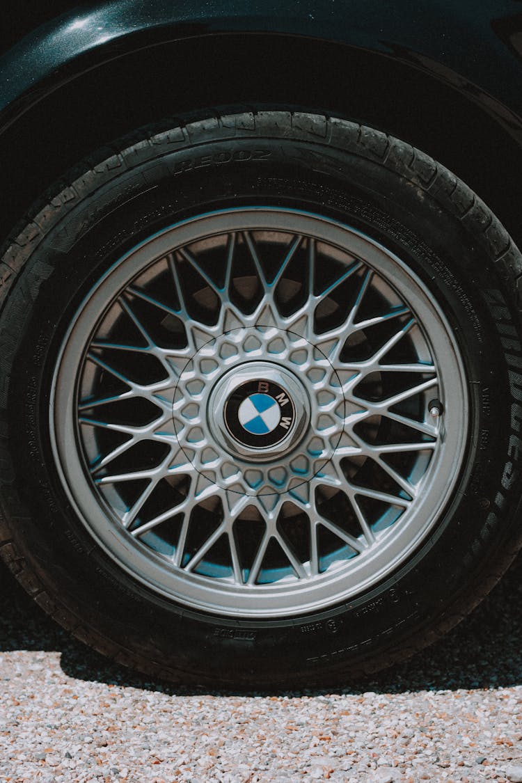 Modern Car Wheel Tire With Ornamental Rim On Road